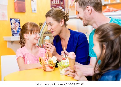 Family In Ice Cream Parlor Enjoying A Sweet Dessert