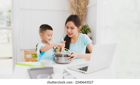 Family joy of asian mother and son having fun making delicious milkshake ice cream by practicing online learning from laptop : Recreation activities mother son baking baking vacation. - Powered by Shutterstock