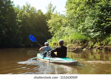 Family Kayak Trip. An Elderly Married Couple Rowing A Boat On The River, A Water Hike, A Summer Adventure. Age-related Sports, Mental Youth And Health, Tourism, Active Old Age