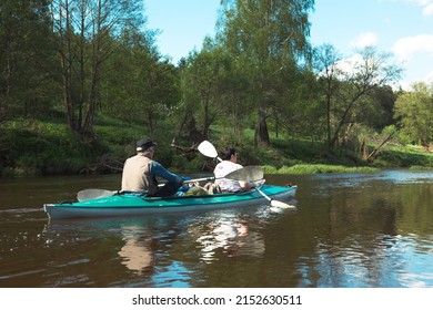 Family Kayak Trip. An Elderly Married Couple Rowing A Boat On The River, A Water Hike, A Summer Adventure. Age-related Sports, Mental Youth And Health, Tourism, Active Old Age