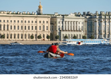 Family kayaking down the historic city river and taking pictures. - Powered by Shutterstock