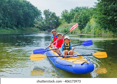 Family Kayaking On The River