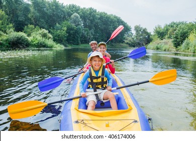 Family Kayaking On The River