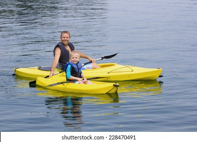 Family Kayaking Together On A Beautiful Lake