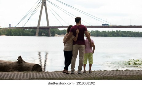 Family With Kid Looking At Bridge, Concept Of Immigration Or Moving To New City