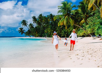 Family With Kid Playing On Tropical Beach