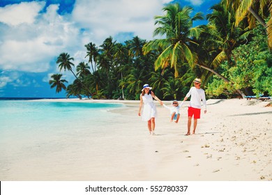 family with kid playing on tropical beach