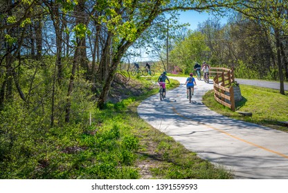 Family With Kids Biking On Bike Trail In Bella Vista, Northwest Arkansas