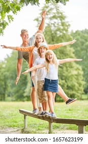 Family And Kids Do A Balance Exercise On The Trim You Path