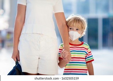 Family With Kids In Face Mask In Shopping Mall Or Airport. Mother And Child Wear Facemask During Coronavirus And Flu Outbreak. Virus And Illness Protection, Hand Sanitizer In Public Crowded Place.