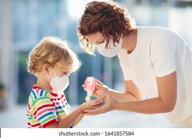 Family with kids in face mask in shopping mall or airport. Mother and child wear facemask during coronavirus and flu outbreak. Virus and illness protection, hand sanitizer in public crowded place. - Shutterstock ID 1641857584