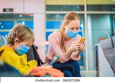 Family With Kids In Face Mask In Shopping Mall Or Airport. Mother And Child Wear Facemask During Coronavirus And Flu Outbreak. Family At Airport Before Flight. Mother And Son In Medical Mask Waiting