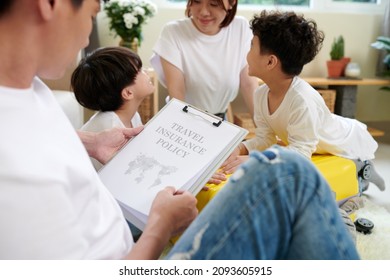 Family With Kids Filling Travel Insurance Policy Document Before Going On Vacation