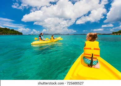 Family With Kids Paddling On Colorful Yellow Kayaks At Tropical Ocean Water During Summer Vacation