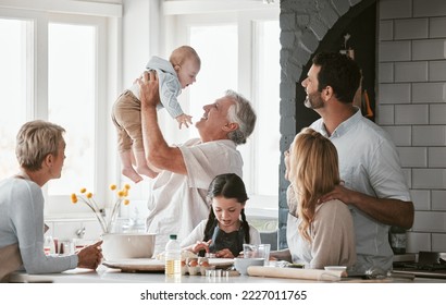 .Family, kitchen and grandpa playing with baby having fun, bonding and relax together. Big family, support or care of grandfather carrying newborn with mother, father and girl child cooking in house. - Shutterstock ID 2227011765