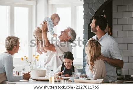 .Family, kitchen and grandpa playing with baby having fun, bonding and relax together. Big family, support or care of grandfather carrying newborn with mother, father and girl child cooking in house.