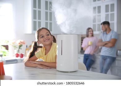 Family In Kitchen With Modern Air Humidifier