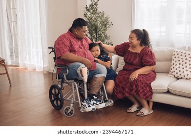 The family of a large, fat man whose father wears a prosthetic leg sits happily together in the kitchen of their home. - Powered by Shutterstock