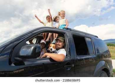 Family Large Group Mom Dad Three Girls And A Boy 6 People And Pet Dog Jack Russell Terrier Going On Vacation By Car