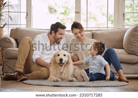 Family laugh, home and dog with child, mom and dad in living room with love in lounge. Animal, pet and mother with father and young kid with happiness in house with golden retriever and care on floor