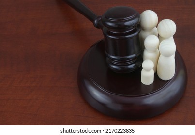 Family Law And Court Concept. Judge Gavel With Family Wooden People Figure. Copy Space For Text.