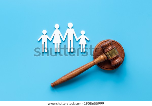 Family law or divorce concept. Family figure with\
judge gavel, top view