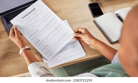 Family lawyer, hands and custody contract with attorney case and notes with agreement in a office. Desk, top view and law firm with planning and paperwork for divorce and document with child support - Powered by Shutterstock