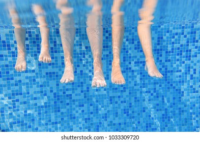 Family Legs Underwater In Swimming Pool, Swim With Children Under Water Funny Concept, Sport And Vacation With Kids