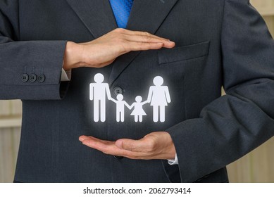 Family life insurance, financial security concept : Businessman protects family members e.g parents and two child, depicts protection from insurer, they will pay a lump sum for clearing burden of debt