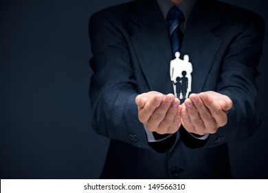 Family Life Insurance, Family Services, Family Policy And Supporting Families Concepts. Businessman With Protective Gesture And Silhouette Representing Young Family.