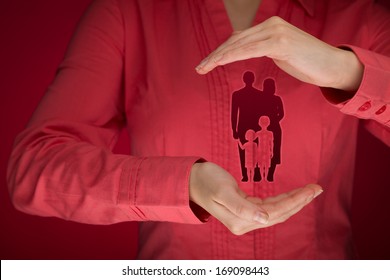 Family Life Insurance, Family Services, Protecting Family, Family Policy And Supporting Families Concepts. Woman With Protective Gesture And Silhouette Representing Young Family. 