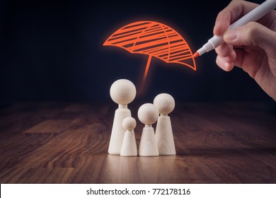 Family life and property insurance concept. Wooden figurines representing family and hand drawing umbrella, symbol of insurance. - Shutterstock ID 772178116