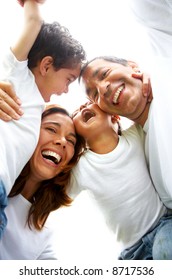 Family Lifestyle Portrait Of A Mum And Dad With Their Two Kids Having Fun Outdoors