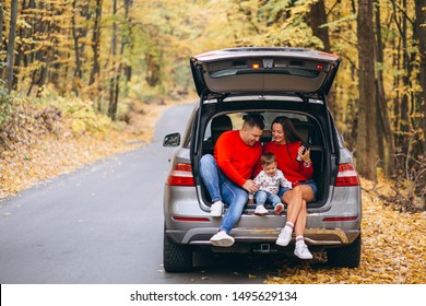 Family With A Little Son In Autumn Park Sitting In Car