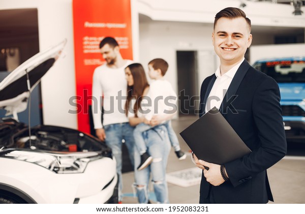 Family with little son in\
a car salon