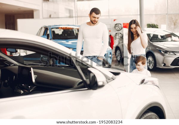 Family with little son in\
a car salon