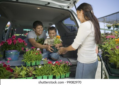 Family Loading Plants Into Minivan