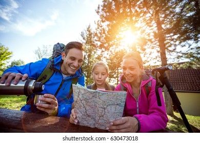 Family Looking At Hiking Map Forest 
