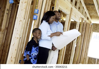family looking at house blueprints
