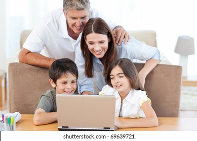 Family Looking At The Laptop At Home
