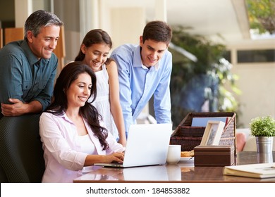 Family Looking At Laptop Together