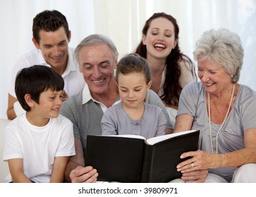 Family Looking At A Photograph Album At Home
