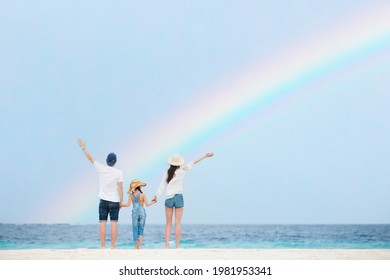 Family Looking Up At The Sky On The Rainbow Beach