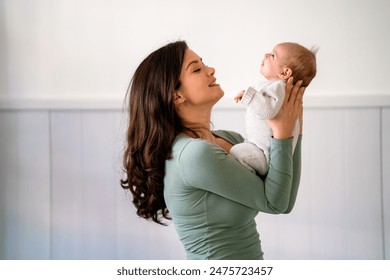 Family love child and parenthood concept. Happy smiling young mother with little baby at home - Powered by Shutterstock