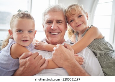 Family, Love And Hug For Grandpa From Children While Sitting Together For A Relationship Portrait, Smile And Bonding At Home. Happy Girl Kids Or Twin Sisters With A Senior Man Having Fun And Playing