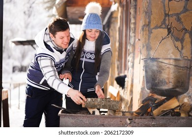 Family In Love Laughing And Cooking In The Winter Outdoors. Bonfire, Barbecue, Bowler.