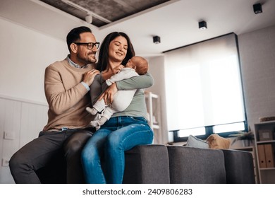 Family love parenthood baby concept. Parents spend happy moments with the newborn child - Powered by Shutterstock