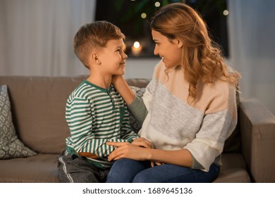 family, love and people concept - happy smiling mother talking to her little son in evening - Powered by Shutterstock