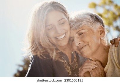 Family, love or smile with a senior mother and daughter bonding outdoor together during a summer day. Happy, flare and retirement with a young man hugging her elderly parent outside in the park - Powered by Shutterstock