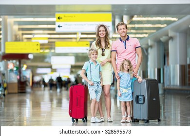 Family With Luggage At The Airport